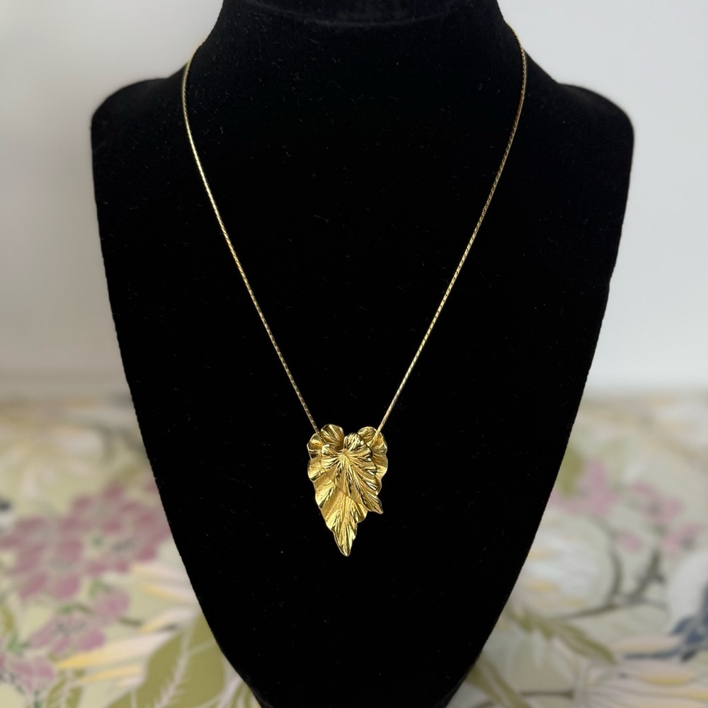 Vintage Monet © gold-tone necklace with a textured leaf pendant.